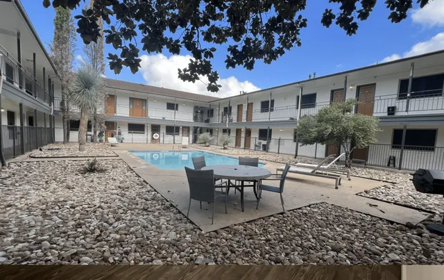 a view of a patio with a table and chairs