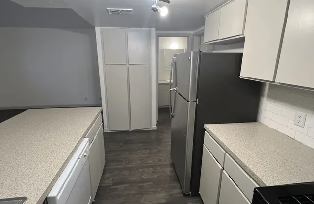 a kitchen with a refrigerator and a sink