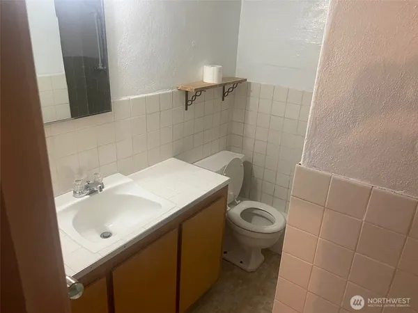 a bathroom with a sink a toilet and a mirror