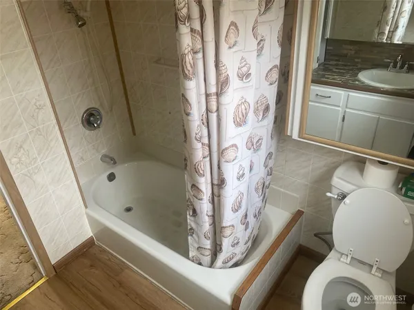 a bathroom with a bathtub and shower