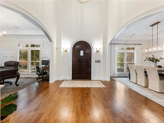 a bedroom with a bed and a wooden floor
