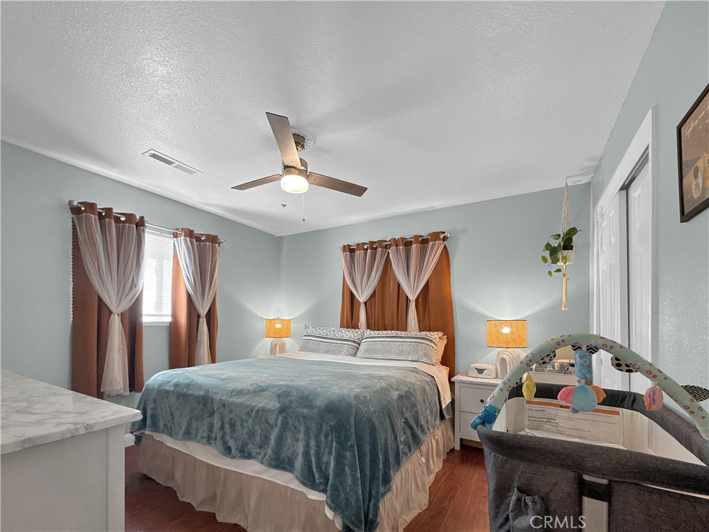 6800 Helton Street Winton, CA 95388 - Photo 13 of 22 a bedroom with a bed and window