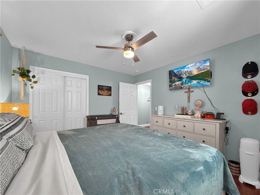 6800 Helton Street Winton, CA 95388 - Photo 19 of 22 a bedroom with a bed and a chandelier