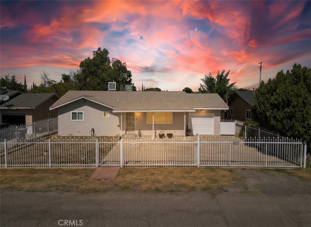 6800 Helton Street Winton, CA 95388 - Photo 2 of 22 front view of a house with a yard
