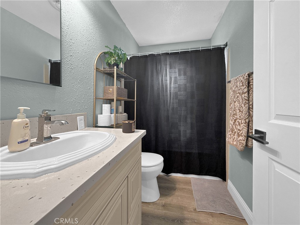 6800 Helton Street Winton, CA 95388 - Photo 22 of 22 a bathroom with a sink a toilet and shower