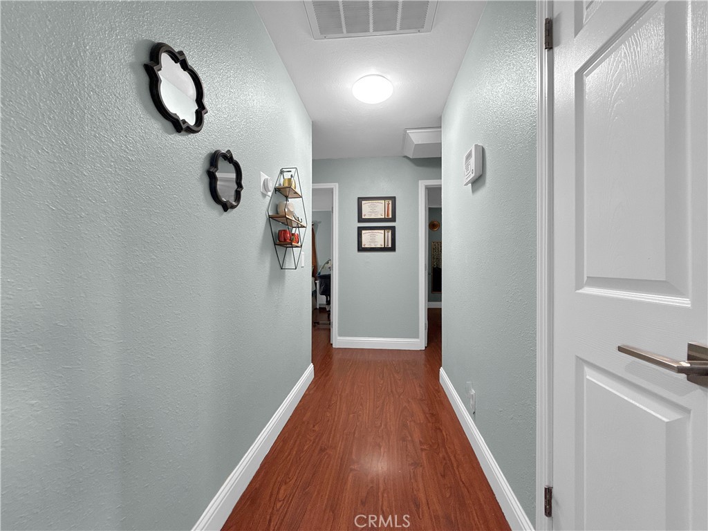 6800 Helton Street Winton, CA 95388 - Photo 6 of 22 a view of a hallway with wooden floor