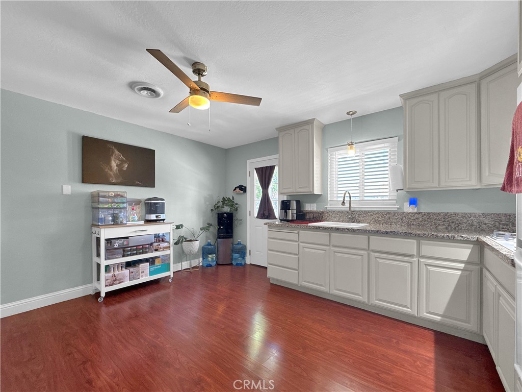 6800 Helton Street Winton, CA 95388 - Photo 10 of 22 a kitchen with stainless steel appliances granite countertop a sink cabinets and wooden floor