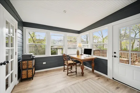 a view of workspace with wooden floor and windows