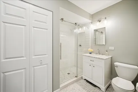 a bathroom with a toilet a sink and shower