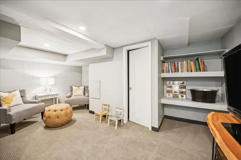 a bedroom with furniture and a book shelf