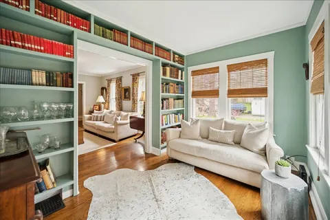 a living room with furniture and a floor to ceiling window