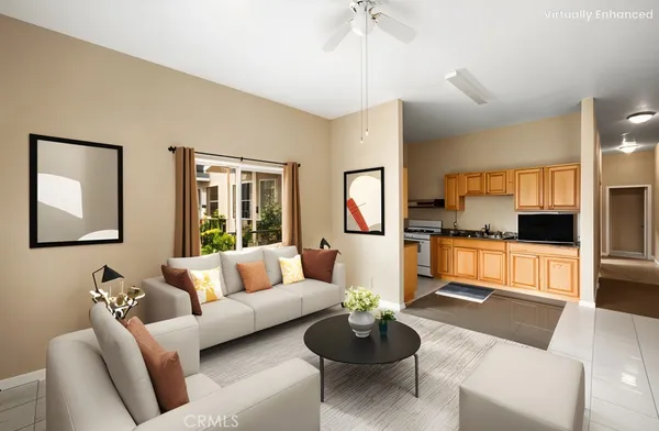 a living room with furniture and a view of kitchen