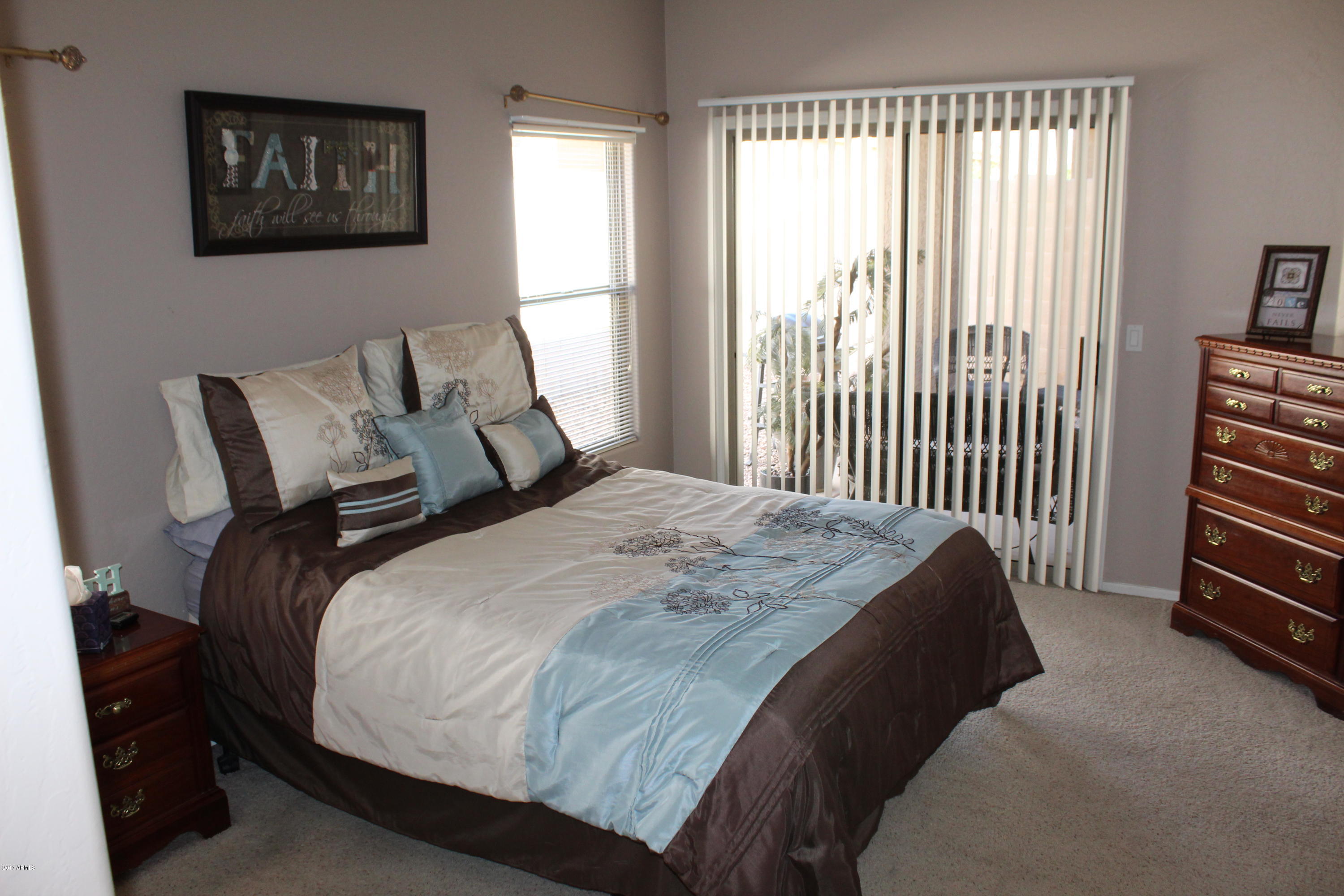 44 South Greenfield Road, Unit 23 Mesa, AZ 85206 - Photo 14 of 28 a bed sitting in a bedroom next to a window