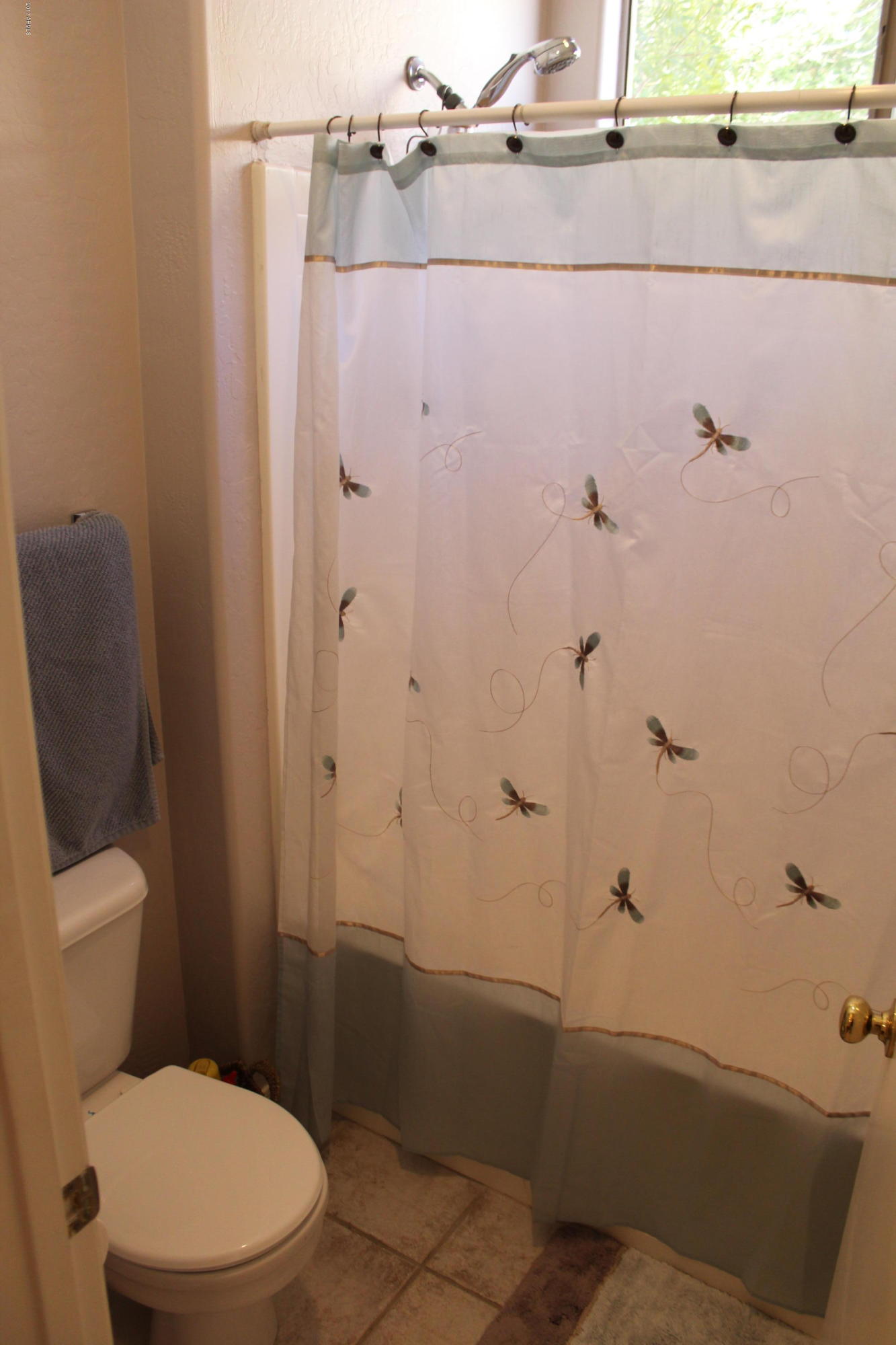 44 South Greenfield Road, Unit 23 Mesa, AZ 85206 - Photo 16 of 28 a bathroom with a toilet and shower
