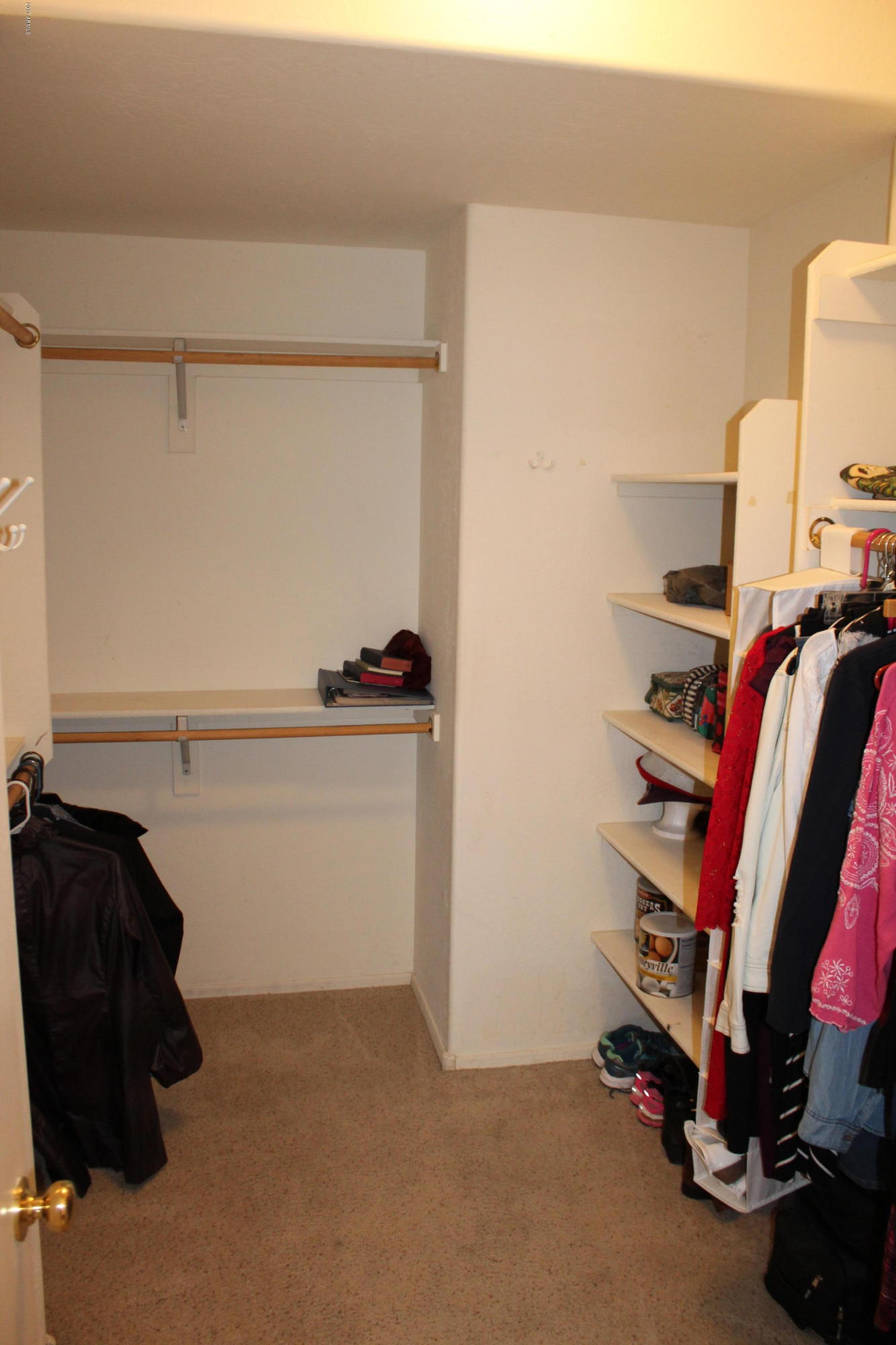 44 South Greenfield Road, Unit 23 Mesa, AZ 85206 - Photo 17 of 28 a view of walk in closet with clothes and shoes
