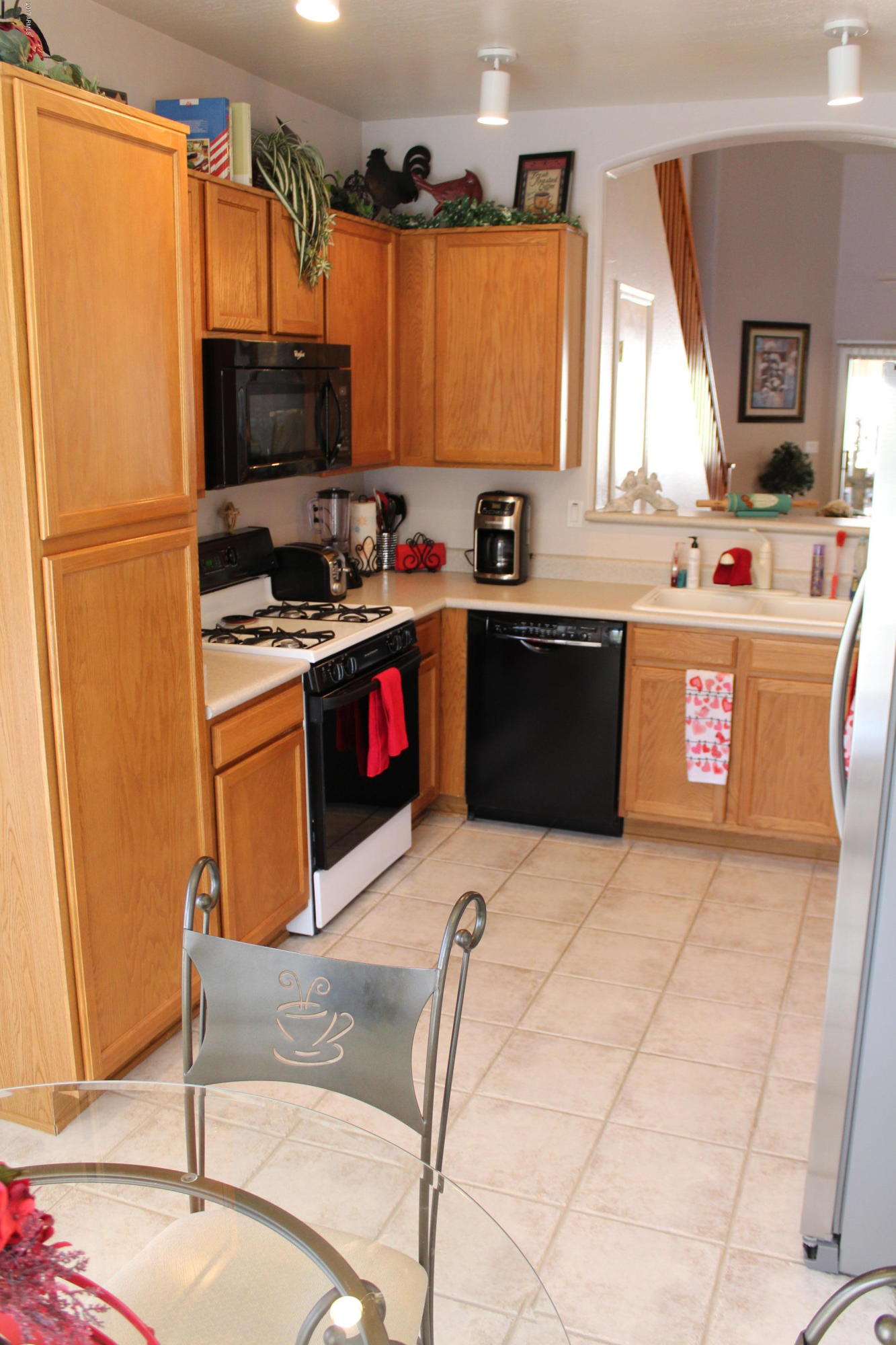 44 South Greenfield Road, Unit 23 Mesa, AZ 85206 - Photo 4 of 28 a kitchen with stainless steel appliances granite countertop a sink stove and refrigerator