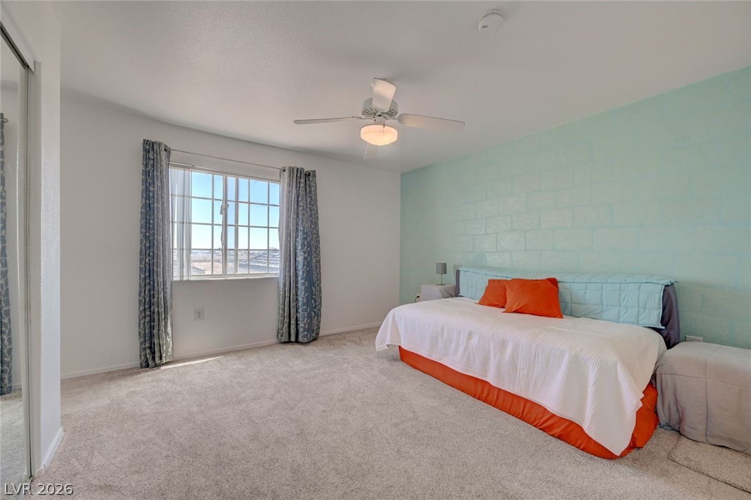 3318 North Decatur Boulevard, Unit 2072 Las Vegas, NV 89130 - Photo 20 of 50 A comfortable bedroom boasts carpet flooring and a refreshing ceiling fan for optimal comfort.