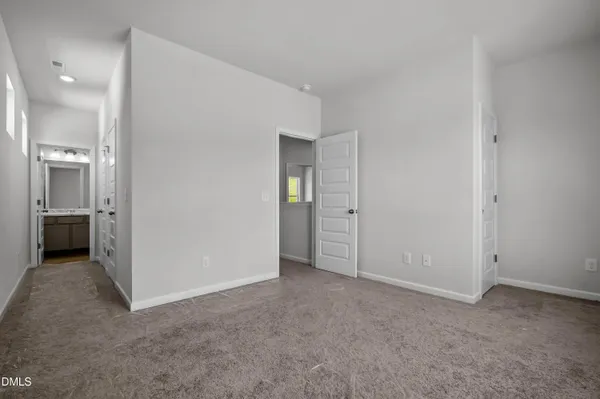 an empty room with an entrance to other room