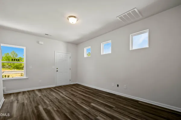 a view of a room with wooden floor and window