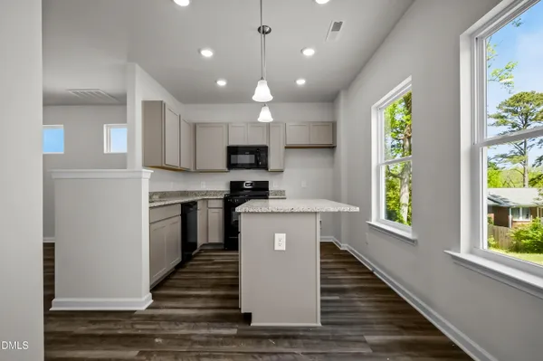 a kitchen with a refrigerator and a stove