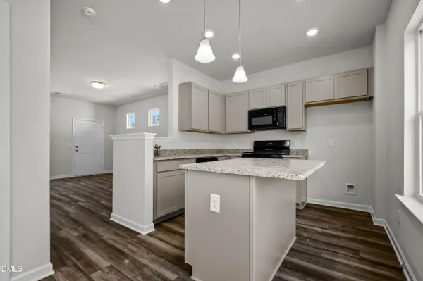 a kitchen with kitchen island a sink stainless steel appliances and cabinets