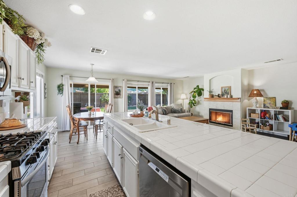 618 Jacks Creek Road Escondido, CA 92027 - Photo 11 of 48 a kitchen with stainless steel appliances granite countertop a stove and a refrigerator
