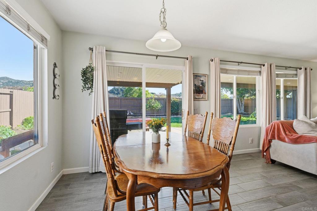 618 Jacks Creek Road Escondido, CA 92027 - Photo 12 of 48 a dining room with furniture wooden floor and a chandelier