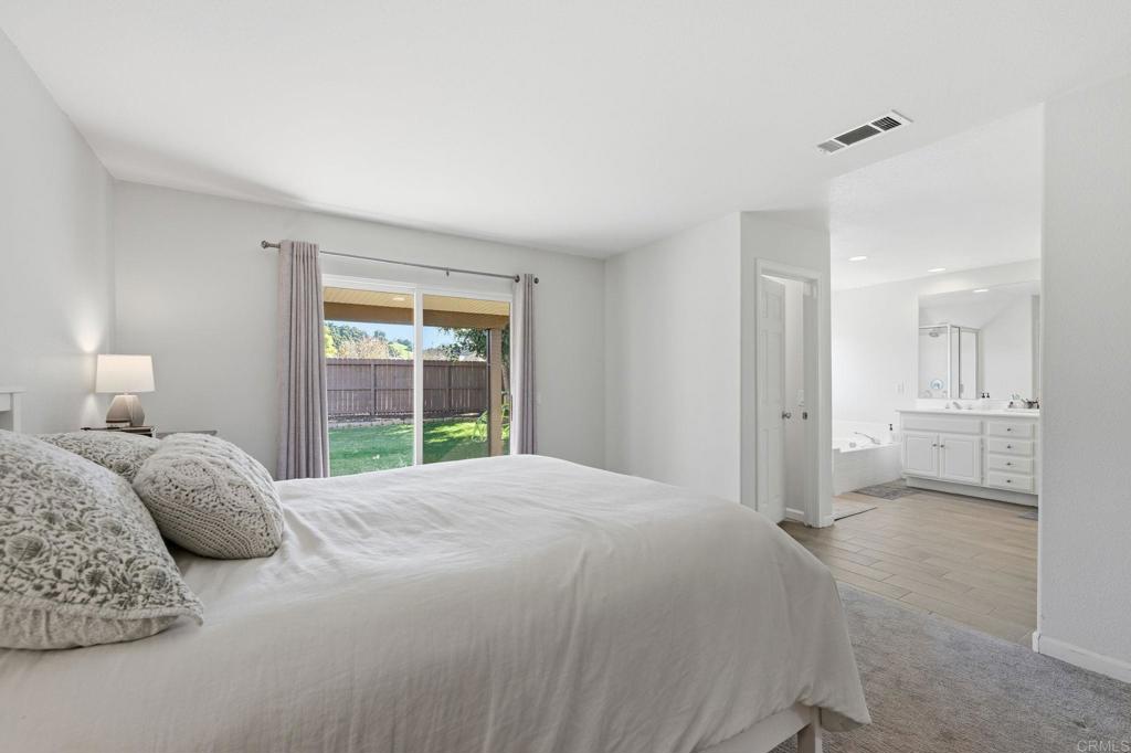618 Jacks Creek Road Escondido, CA 92027 - Photo 20 of 48 a spacious bedroom with a bed and a window