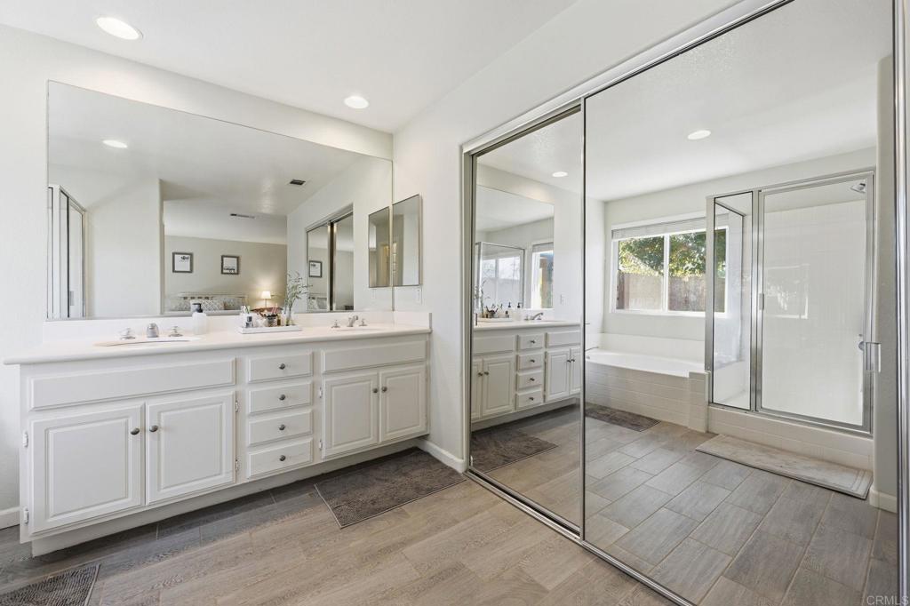 618 Jacks Creek Road Escondido, CA 92027 - Photo 22 of 48 a spacious bathroom with a granite countertop sink mirror and cabinets