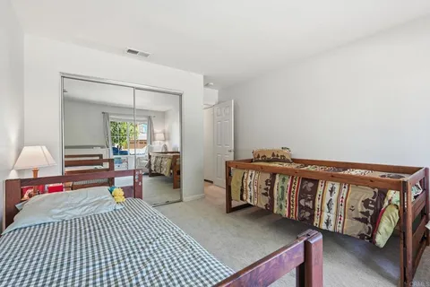 a bedroom with furniture and a wooden floor