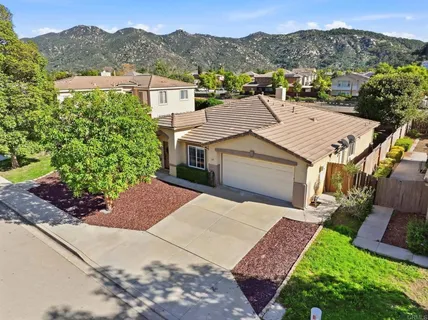 an aerial view of a house with a yard