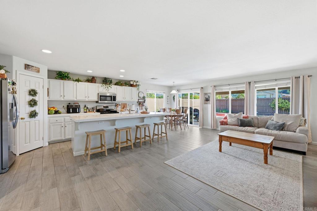 618 Jacks Creek Road Escondido, CA 92027 - Photo 6 of 48 a living room with stainless steel appliances kitchen island granite countertop furniture and a wooden floor