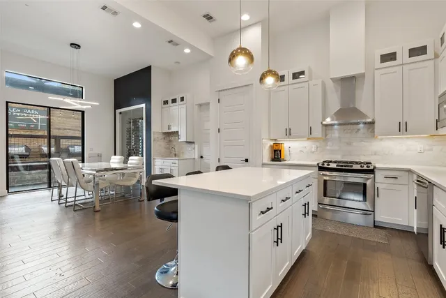 a kitchen with a sink stove and cabinets
