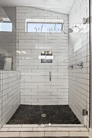 a bathroom with a double vanity sink and a mirror