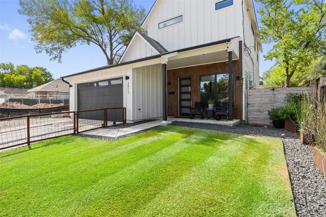 a view of a house with a yard and porch