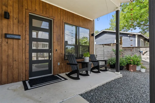 a view of a two chairs in the patio and a room