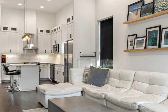 a living room with furniture and kitchen view
