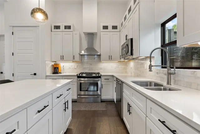 a kitchen with stainless steel appliances a sink stove and cabinets