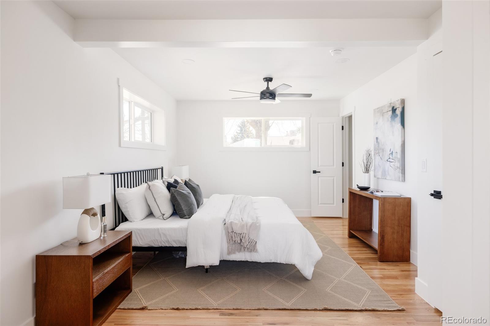 7255 West 35th Place Wheat Ridge, CO 80033 - Photo 17 of 30 a spacious bedroom with a bed and window