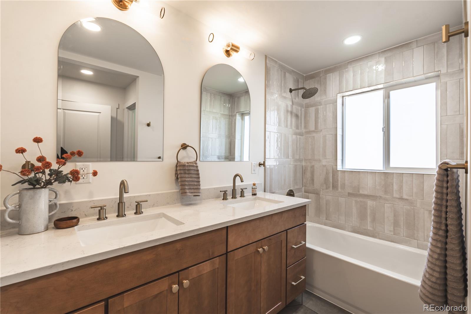7255 West 35th Place Wheat Ridge, CO 80033 - Photo 20 of 30 a bathroom with a double vanity sink mirror double and bathtub