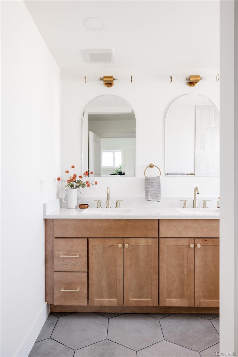 7255 West 35th Place Wheat Ridge, CO 80033 - Photo 21 of 30 a bathroom with a sink and a mirror