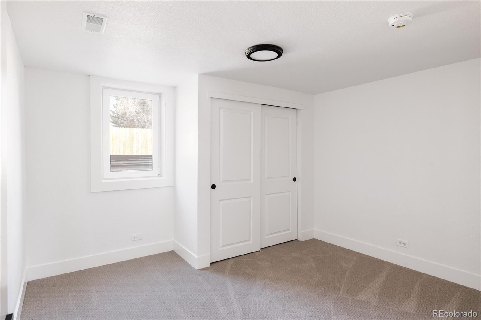 7255 West 35th Place Wheat Ridge, CO 80033 - Photo 28 of 30 an empty room with windows