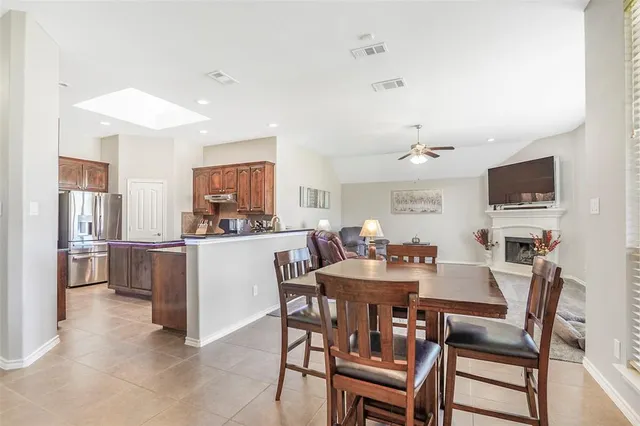 a view of a dining room with furniture and a kitchen
