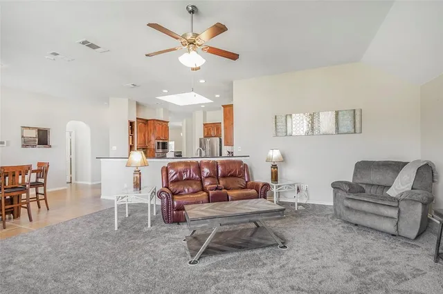 a living room with furniture and a chandelier