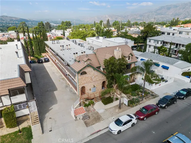 an aerial view of multiple houses with yard