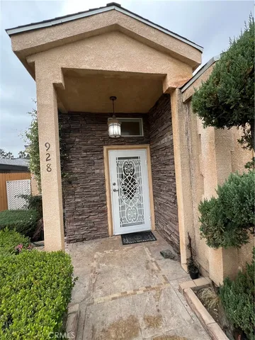a view of a house with a door and wooden walls