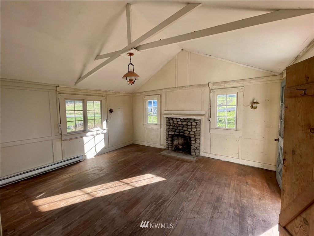546 Glenwood Inn Road Orcas Island, WA 98245 - Photo 19 of 25 a view of empty room with wooden floor and fireplace