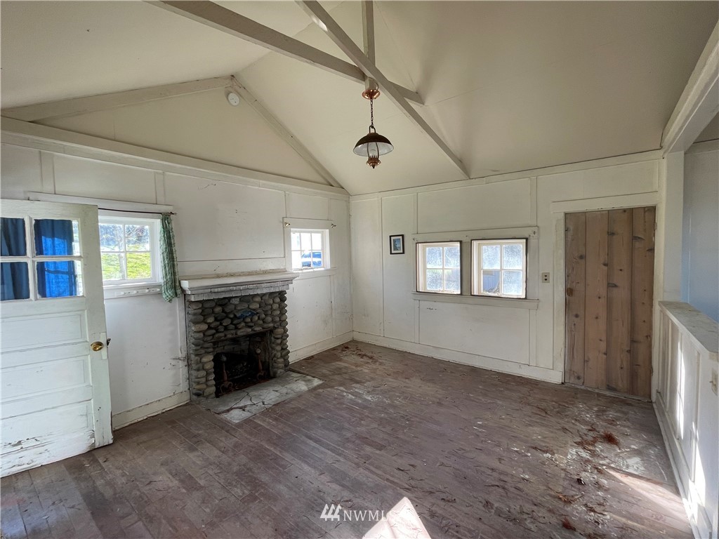 546 Glenwood Inn Road Orcas Island, WA 98245 - Photo 22 of 25 an empty room with windows and fireplace