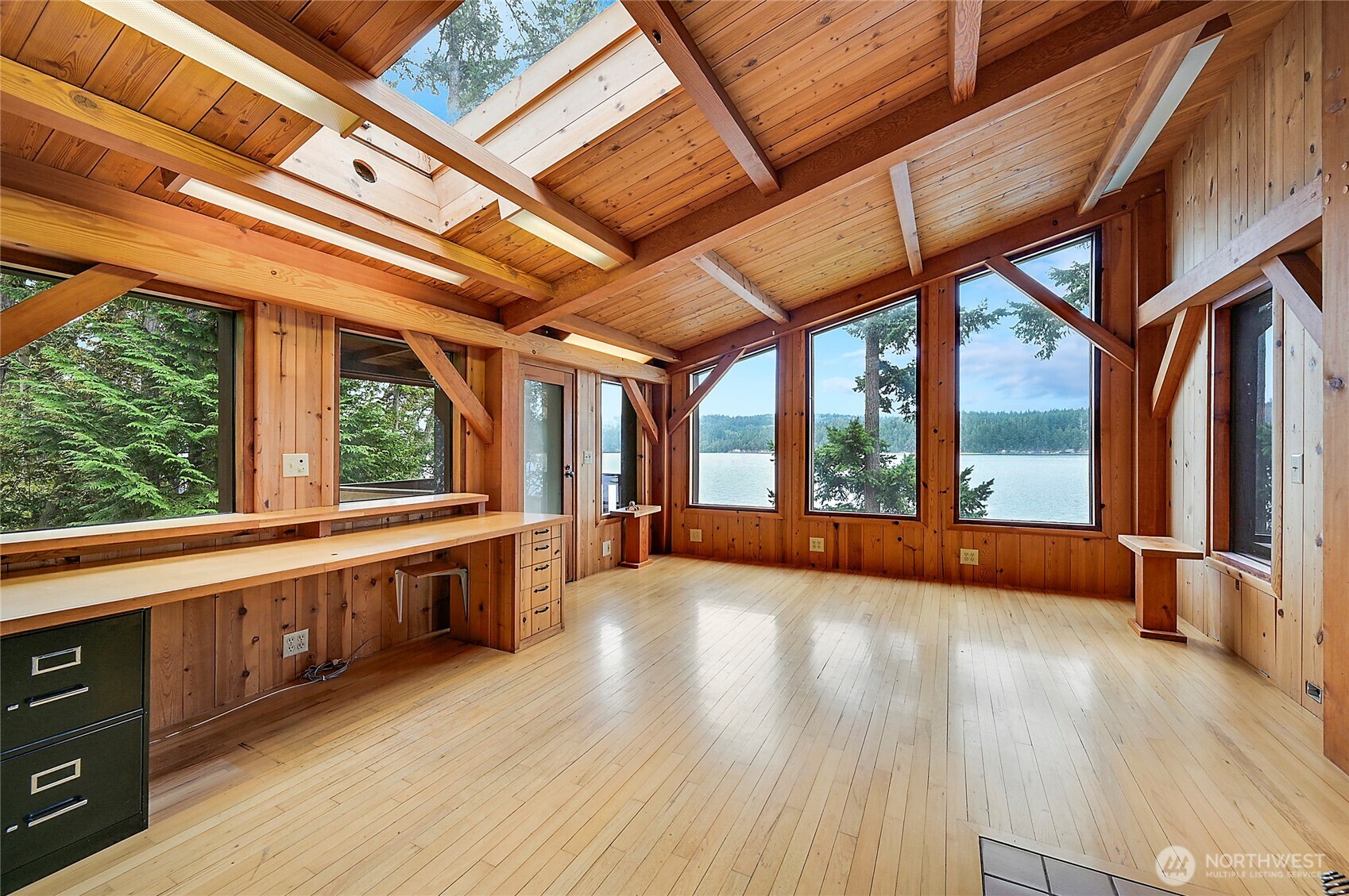 861 Griffith Point Road Nordland, WA 98358 - Photo 24 of 38 a view of an empty room with wooden floor and a window