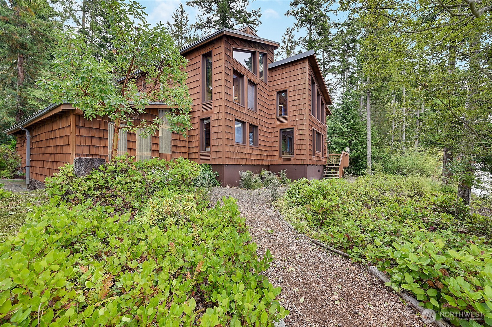 861 Griffith Point Road Nordland, WA 98358 - Photo 37 of 38 a view of a house with a yard and plants
